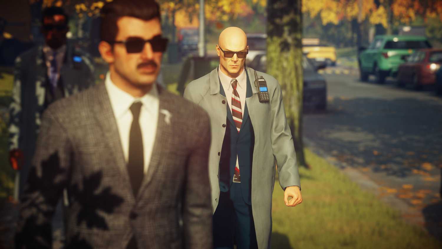 Agent 47 stalking a guard in the suburbs in Hitman: World of Assassination.