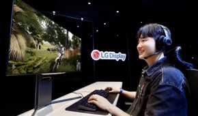 A person playing a game on an OLED monitor next to an LG Display logo