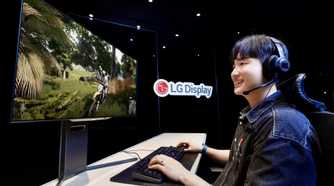 A person playing a game on an OLED monitor next to an LG Display logo