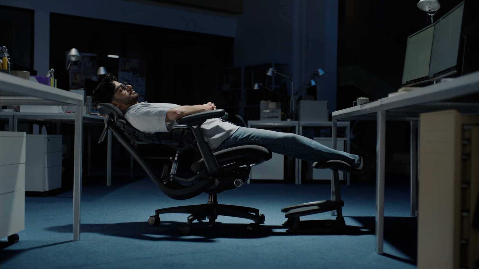 Man leaning on a chair.