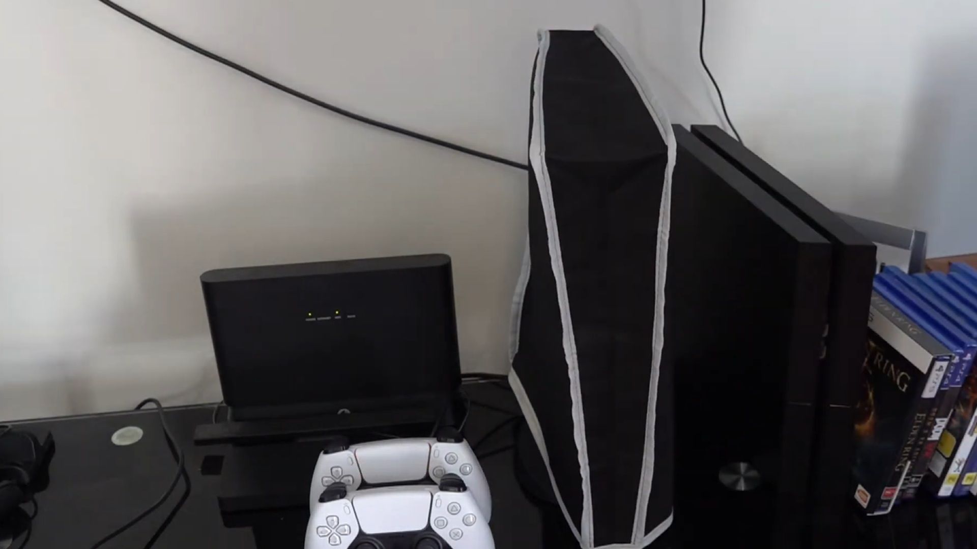A shot of a setup with a nylon dust cover over the PlayStation 5