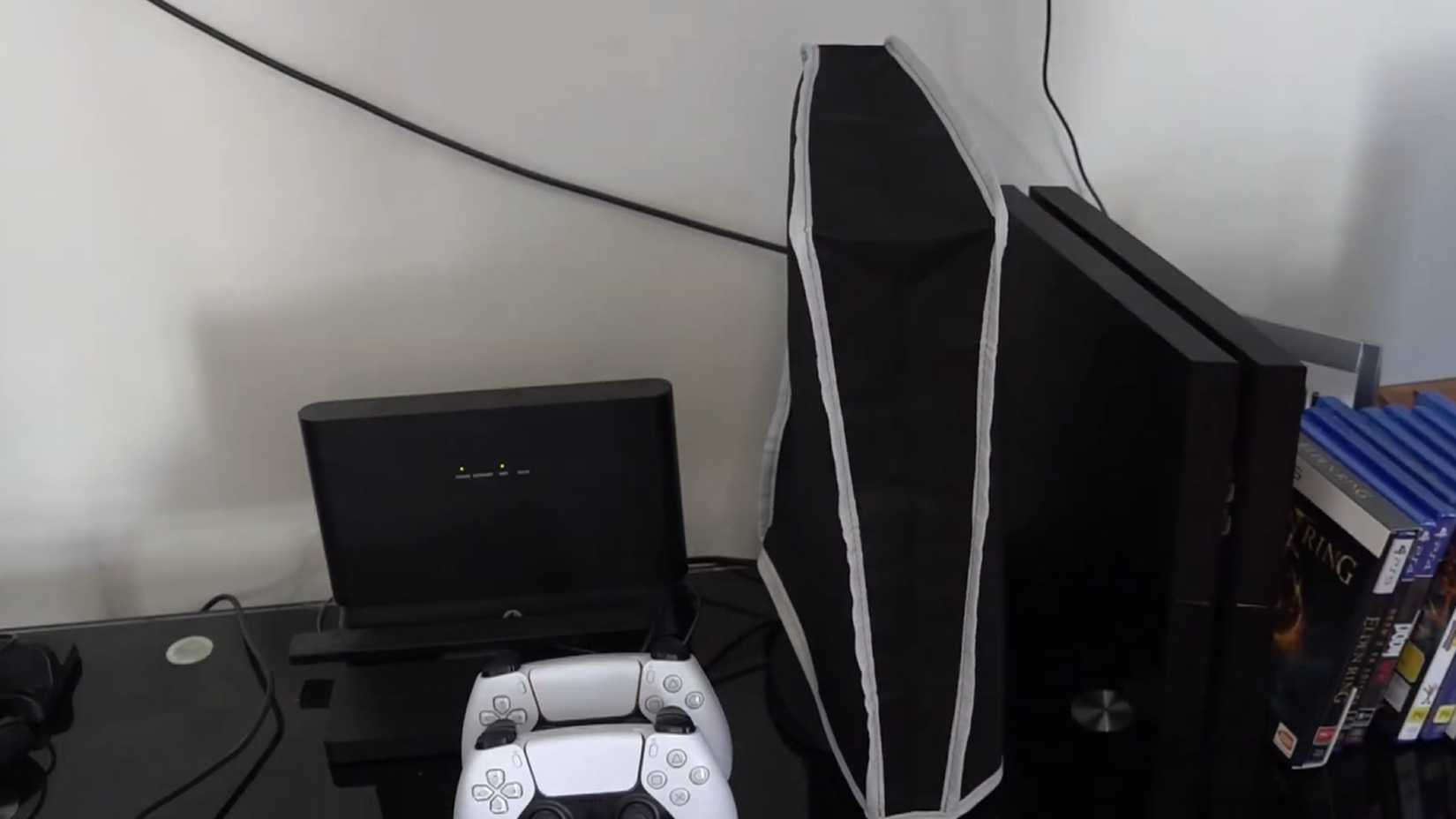 A shot of a setup with a nylon dust cover over the PlayStation 5