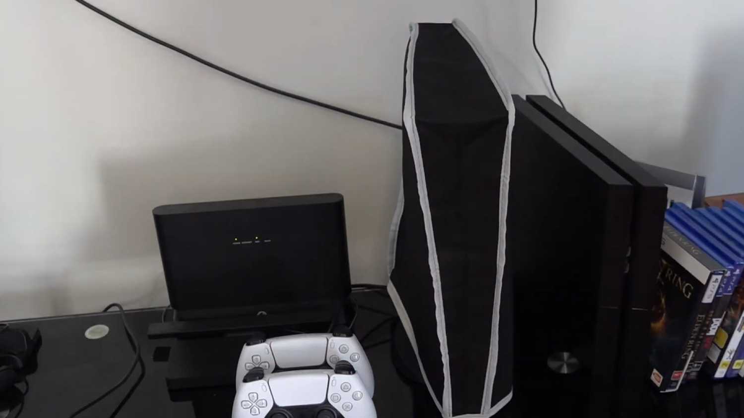 A shot of a setup with a nylon dust cover over the PlayStation 5