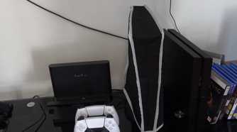 A shot of a setup with a nylon dust cover over the PlayStation 5