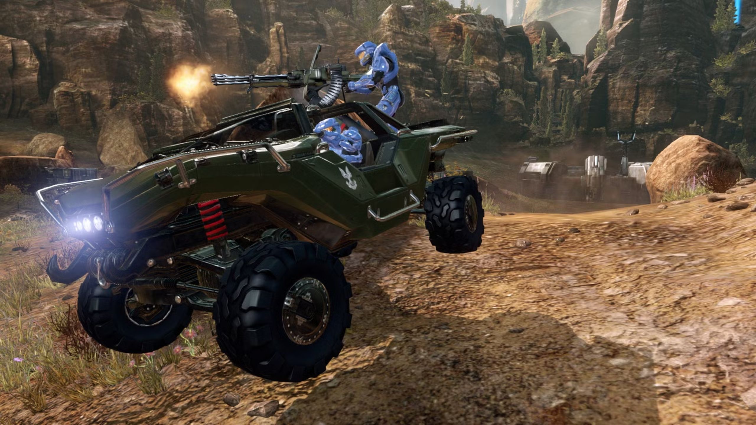 Blue team players in Halo riding a Warthog.
