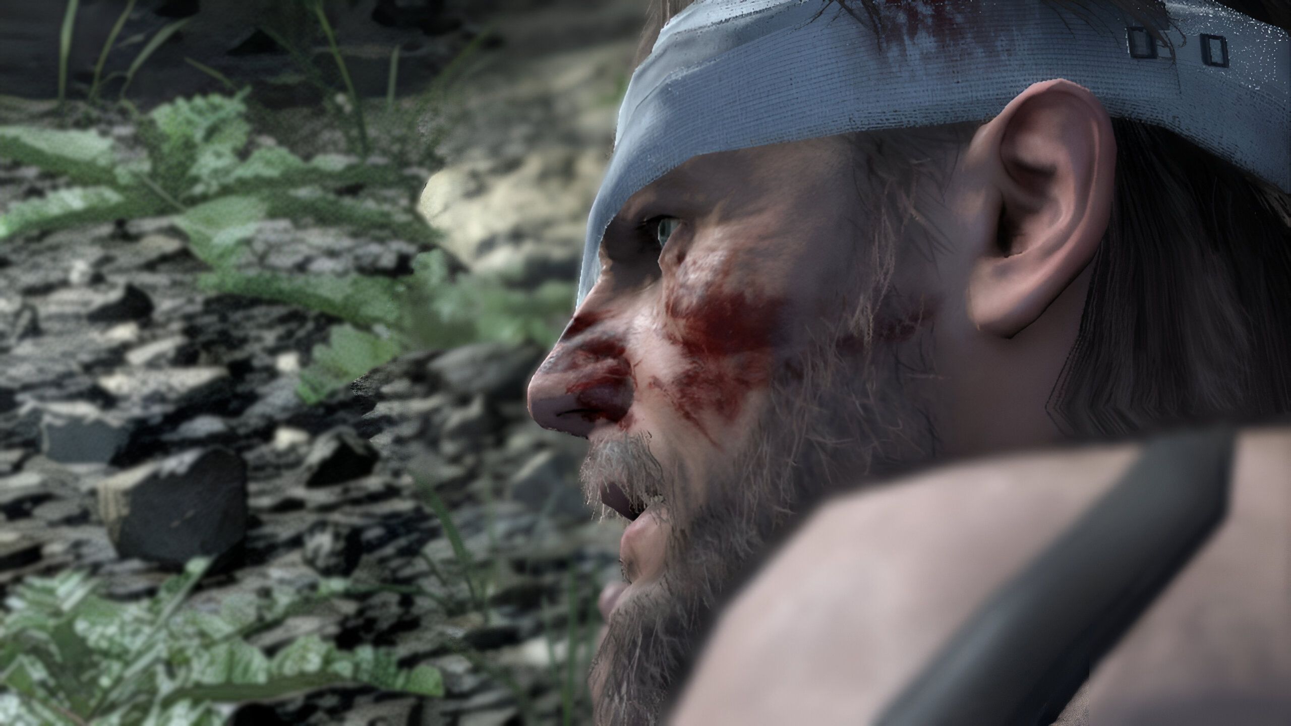 Venom Snake crawling on the ground in Metal Gear Solid V: The Phantom Pain.