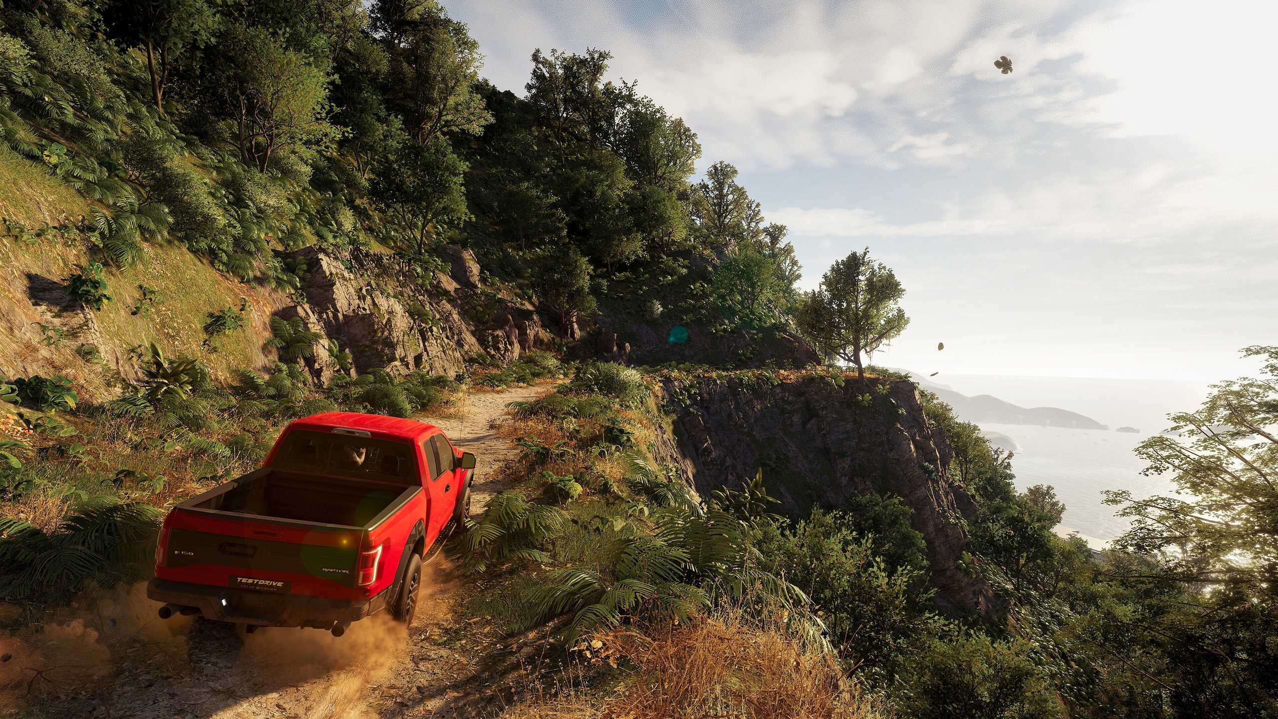 An F-150 Raptor driving down a mountain trail in Hawaii in Test Drive Unlimited Solar Crown.