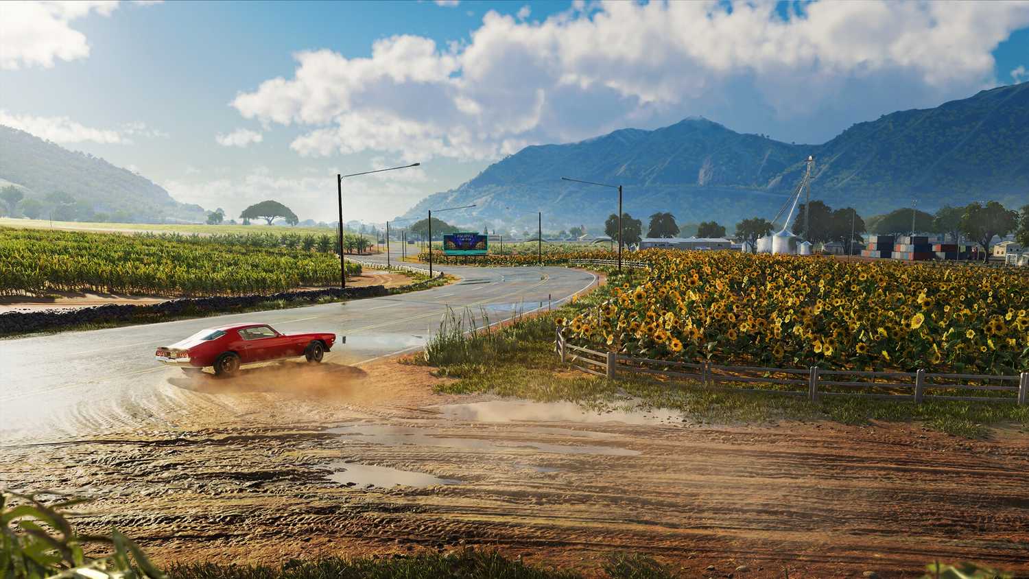 A muscle car drifting next to sunflower fields in Hawaii in The Crew: Motorfest.