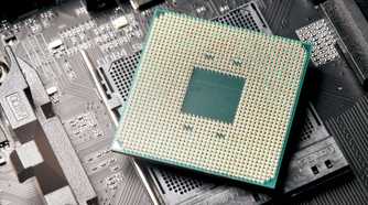 A CPU resting on a motherboard socket with the CPU pins visible