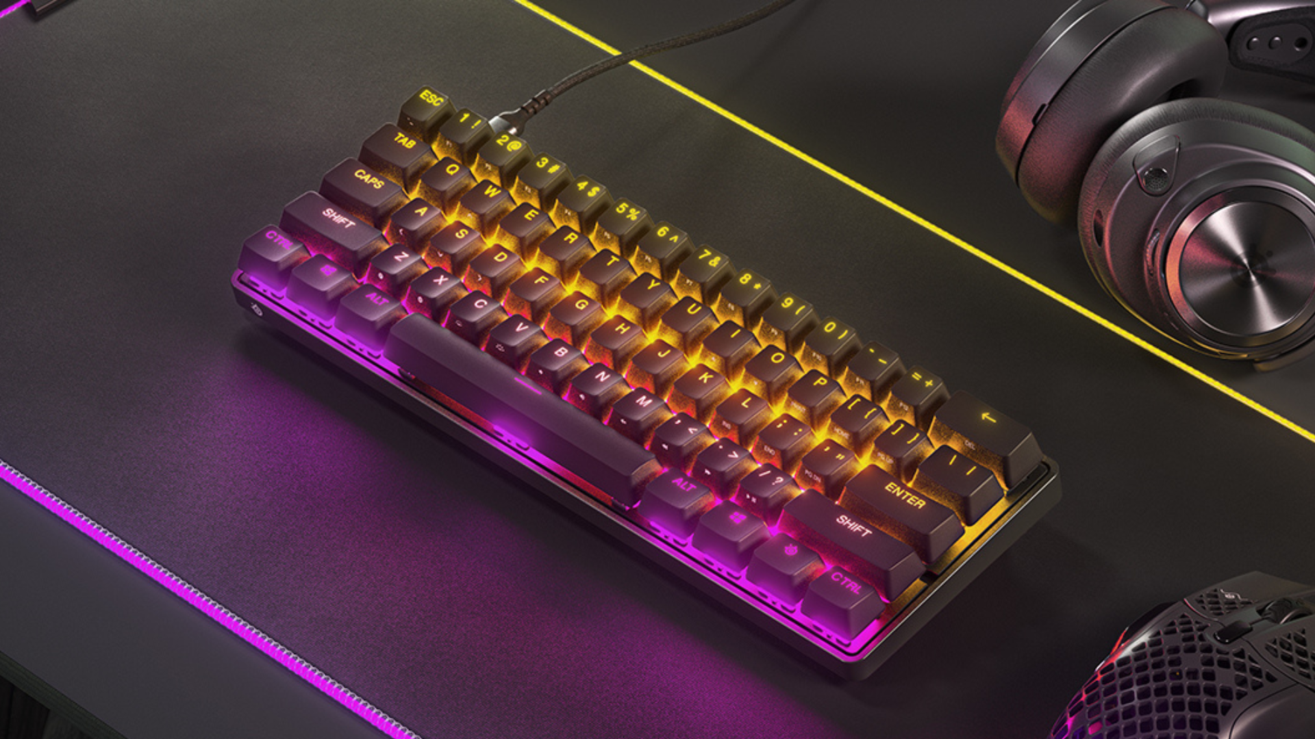 SteelSeries Apex 9 Mini on desk next to headphones and mouse