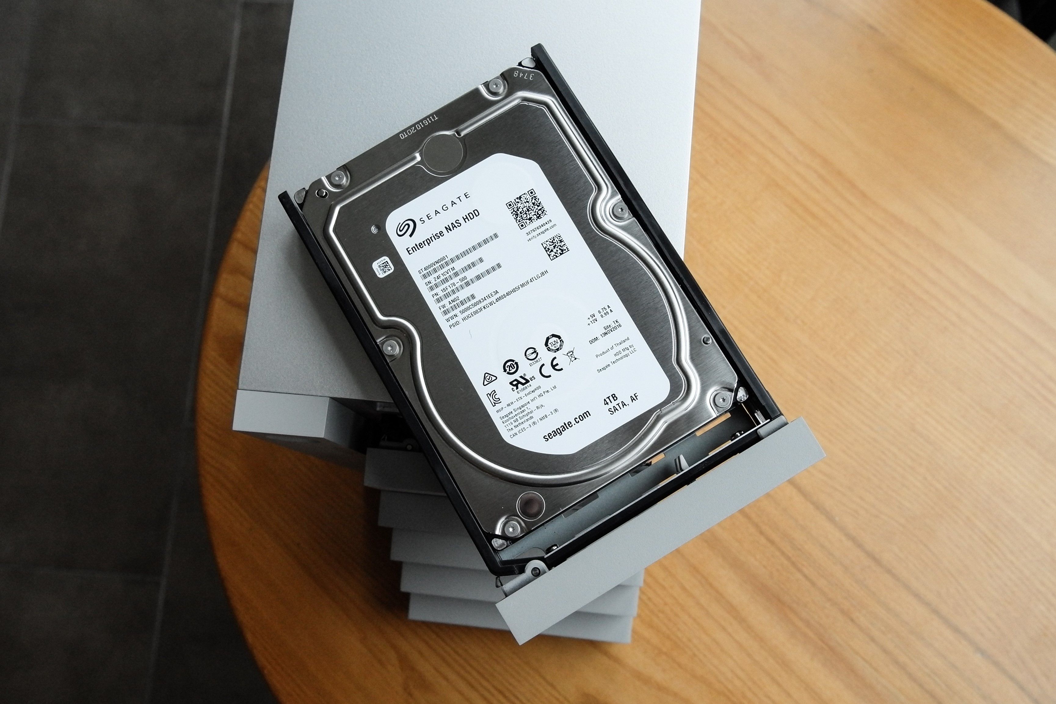 An enterprise hard drive with a wooden desk in the background