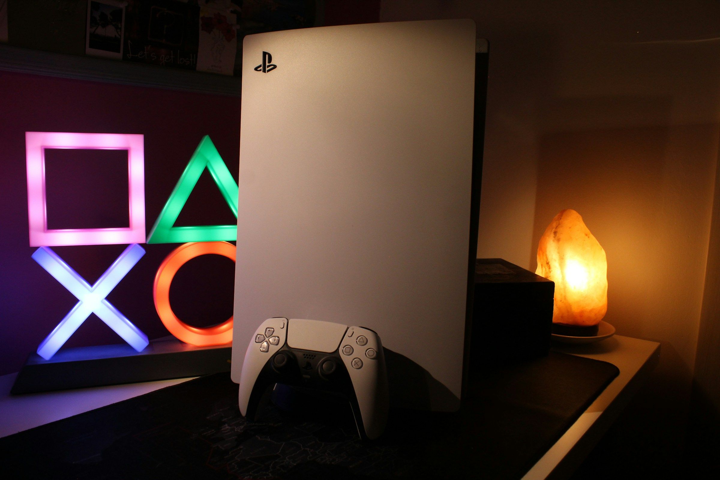 A PlayStation 5 console in warm lighting.