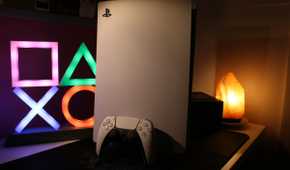 A PlayStation 5 console in warm lighting.