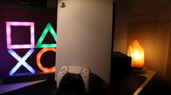 A PlayStation 5 console in warm lighting.