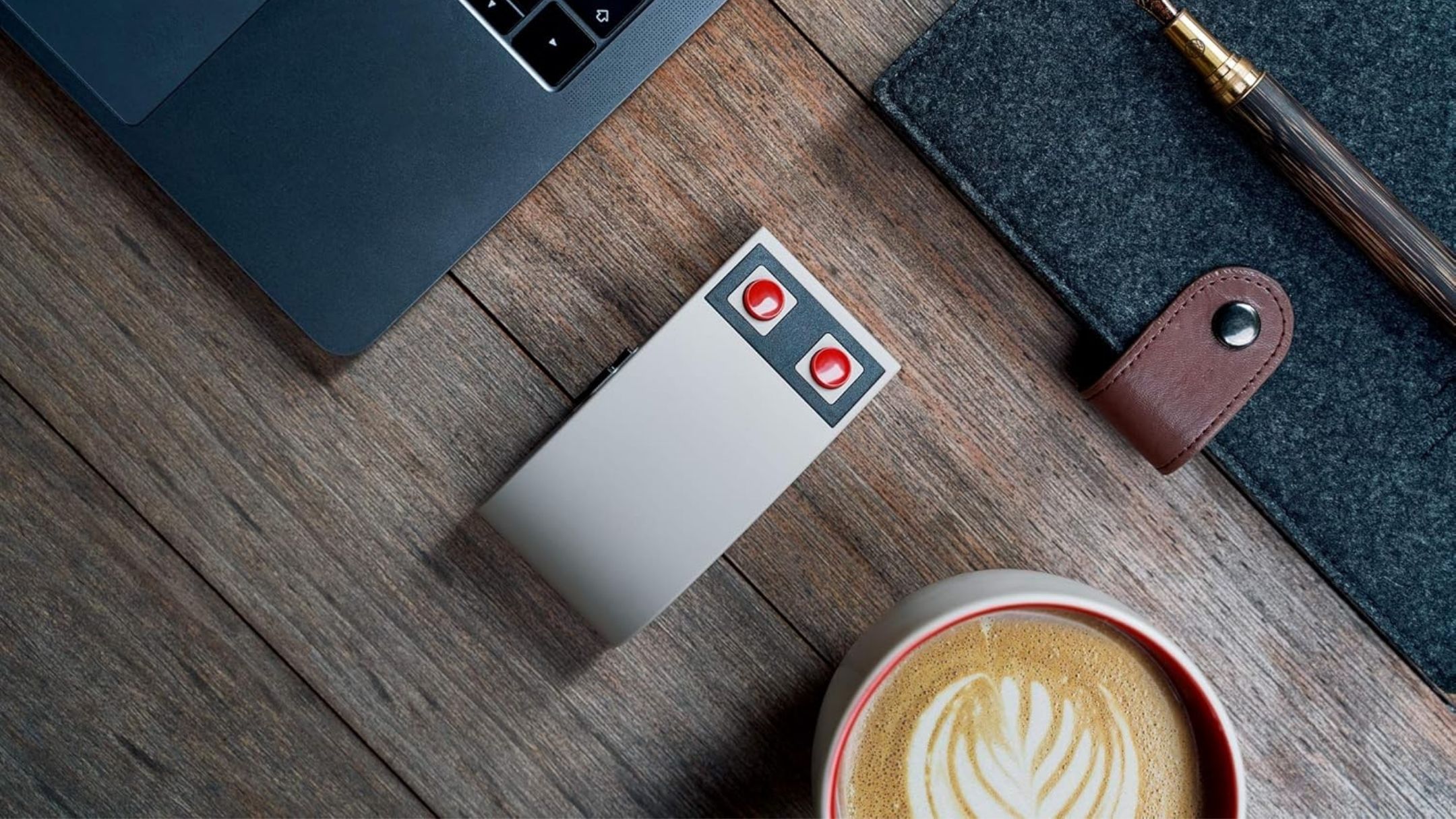 8Bitdo N30 mouse on the desk next to laptop and coffee