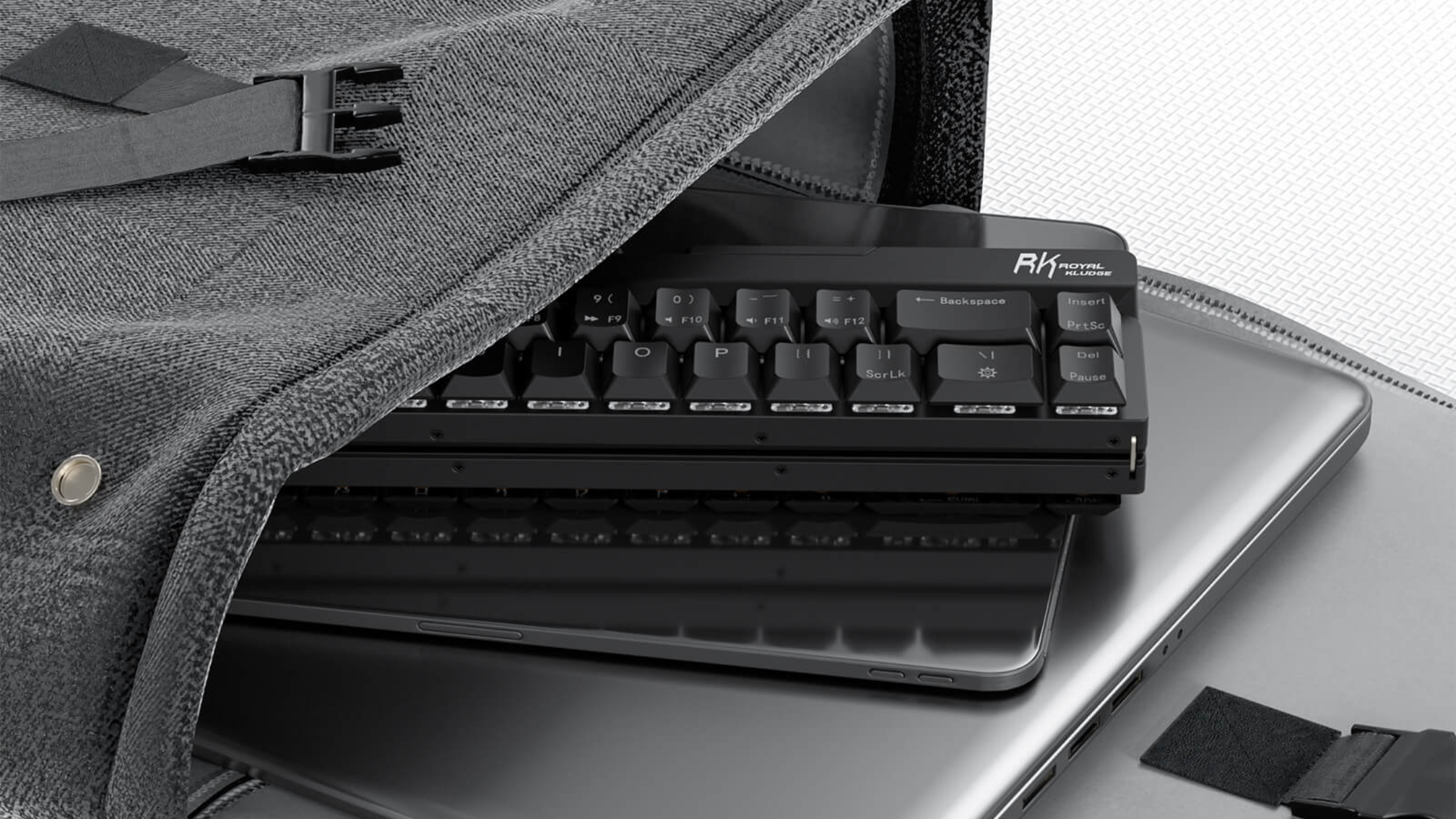 RK ROYAL KLUDGE F68 60% Foldable Low Profile Mechanical Keyboard in a bag with laptop