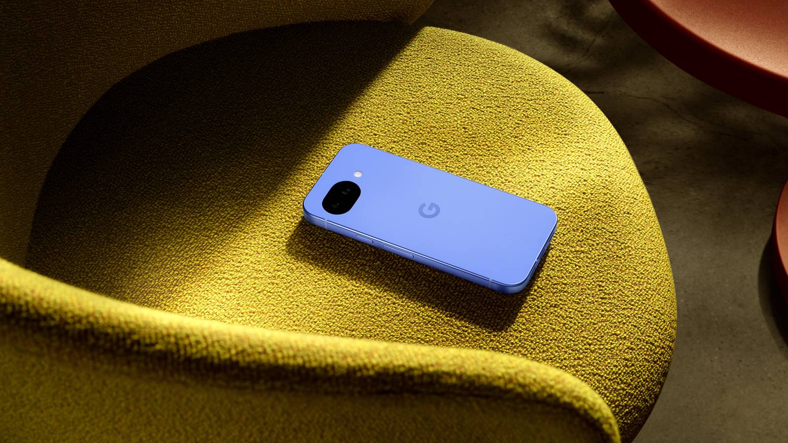 A render of the Pixel 10a sitting on a yellow chair