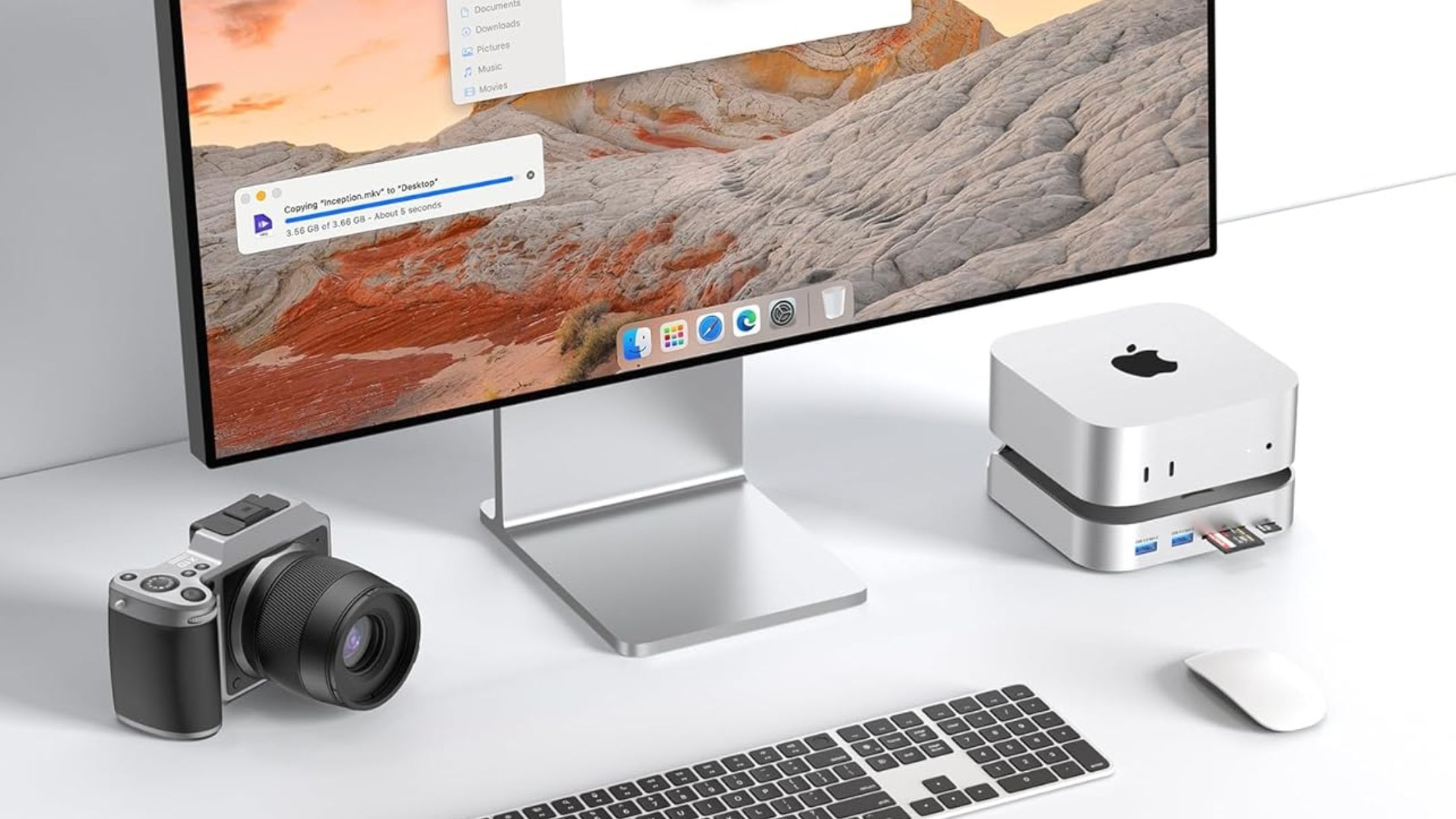 BAOZEE Mac mini M4 Dock with NVMe SSD Enclosure next to monitor