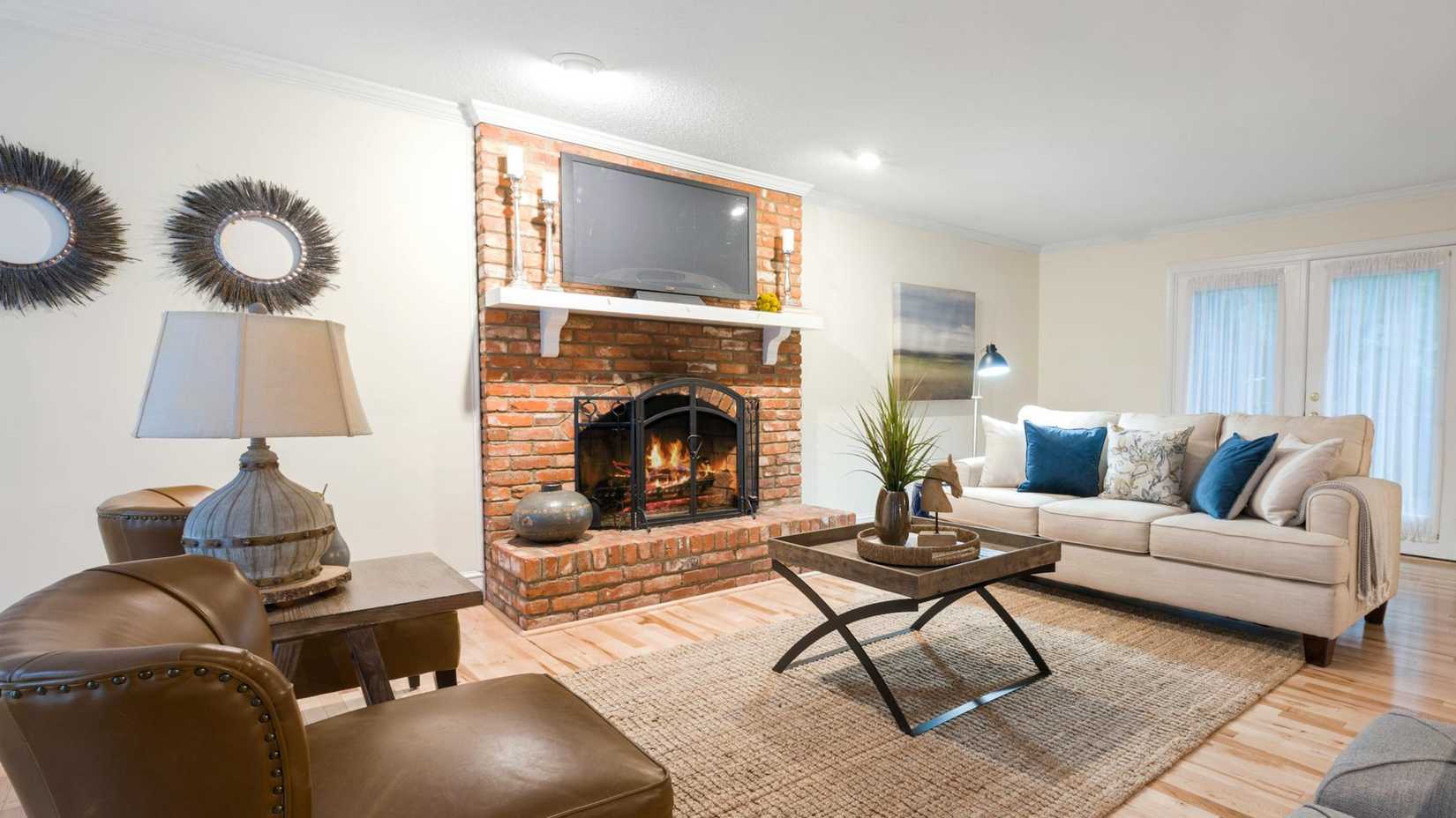 Flatscreen TV mounted over a fireplace.