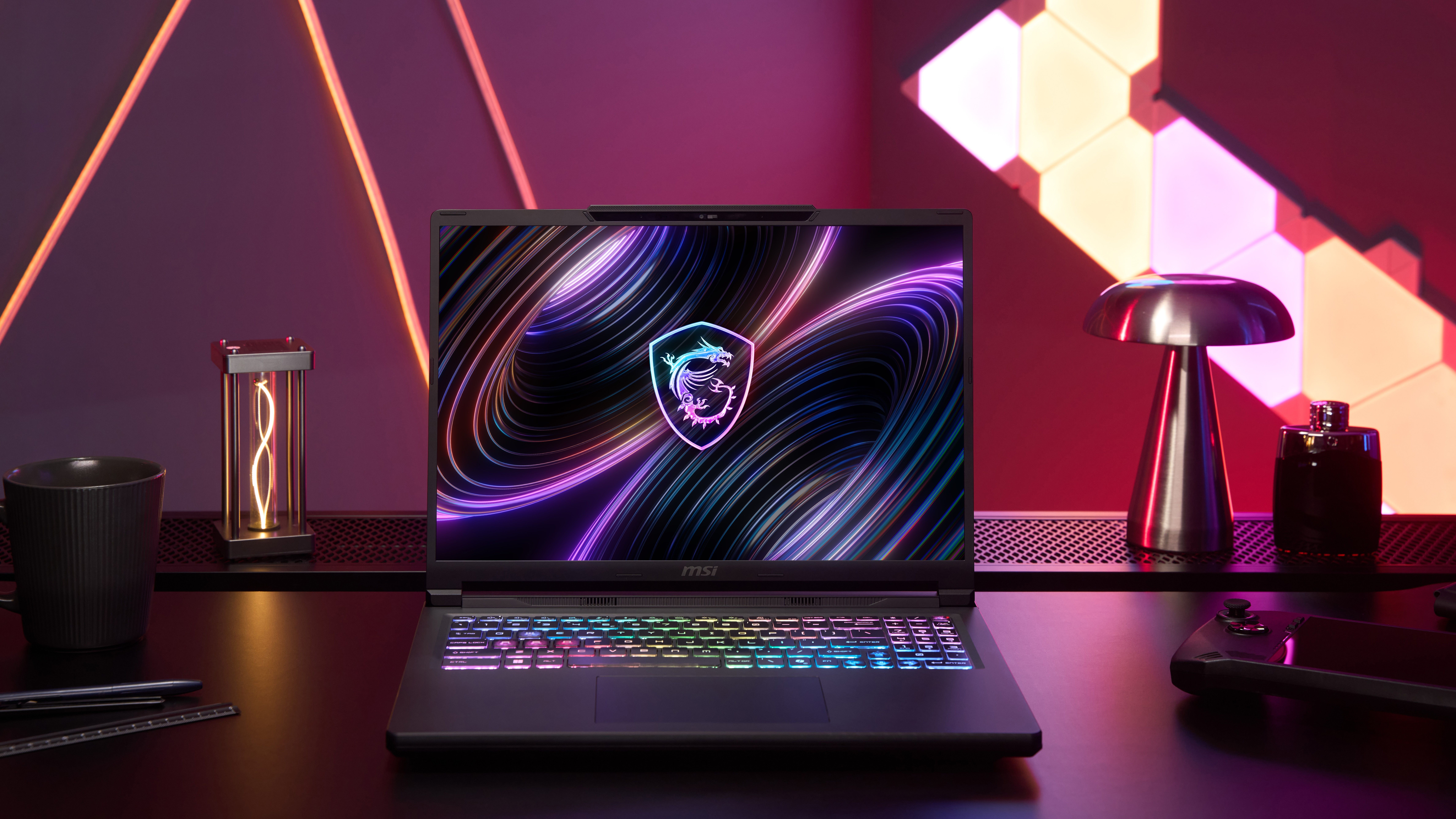 The MSI Raider 16 Max HX ib a desk with purple lighting