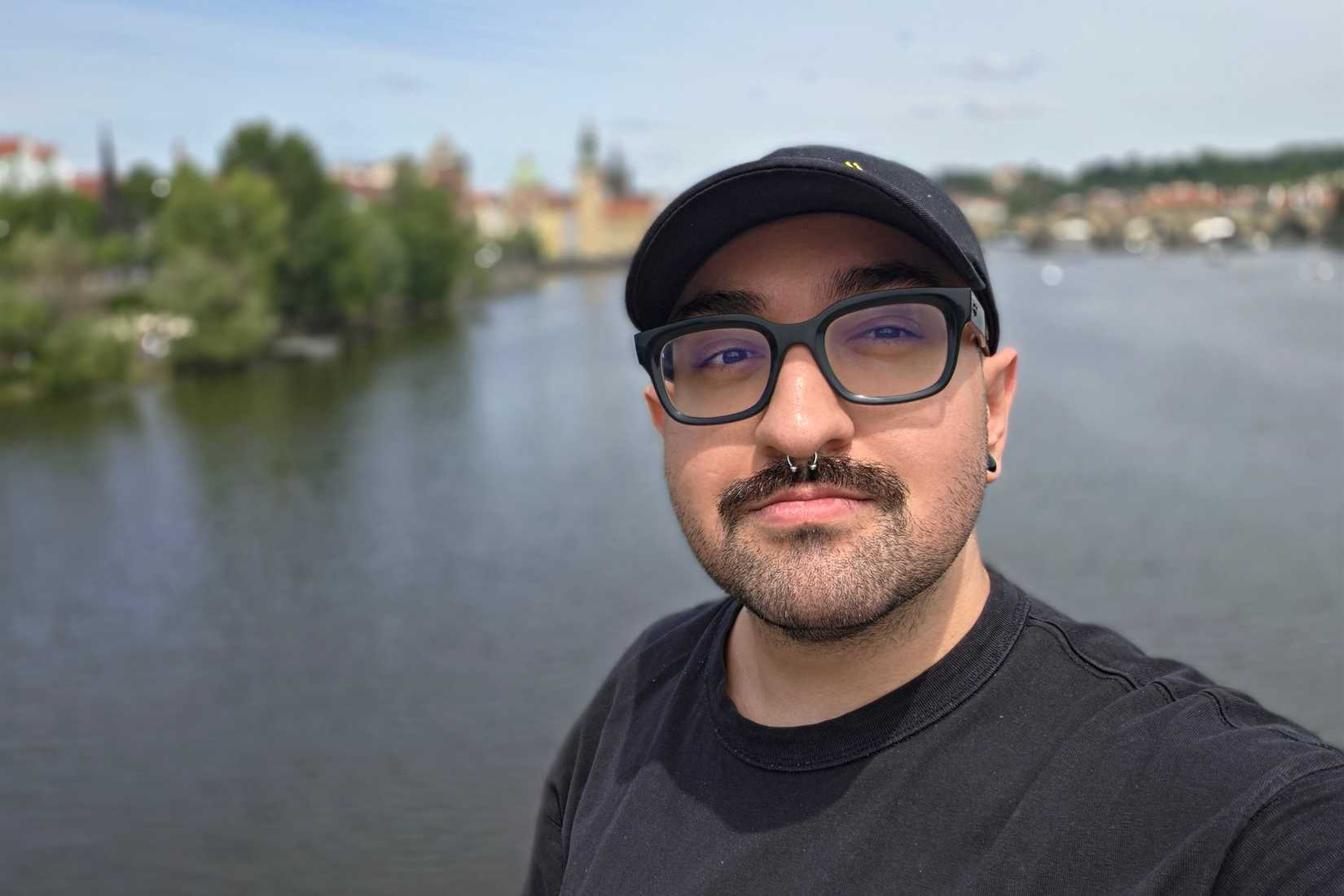 A selfie of Yasan standing by a water body