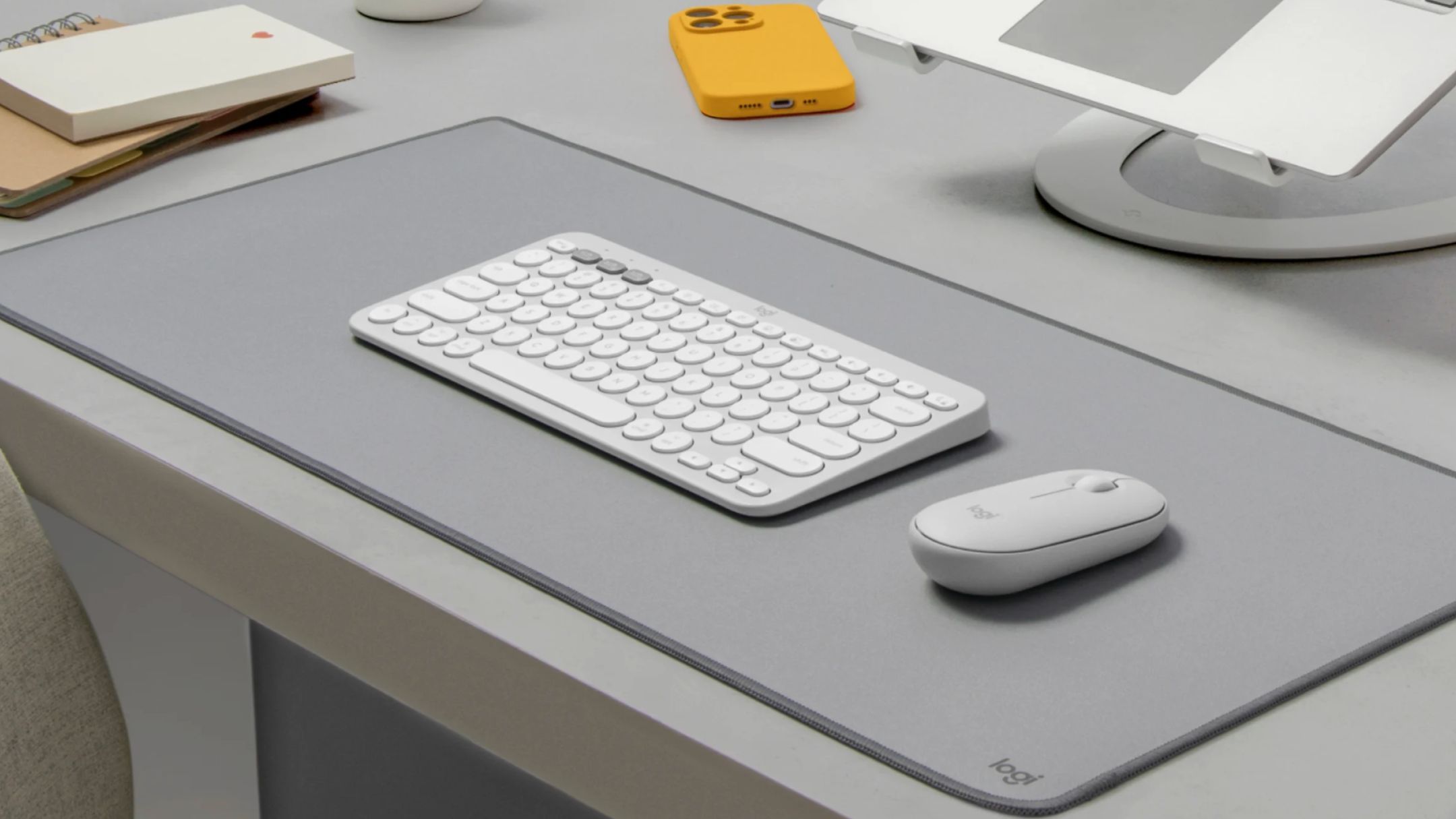 Pebble Mouse 2 M350s on desk next to keyboard