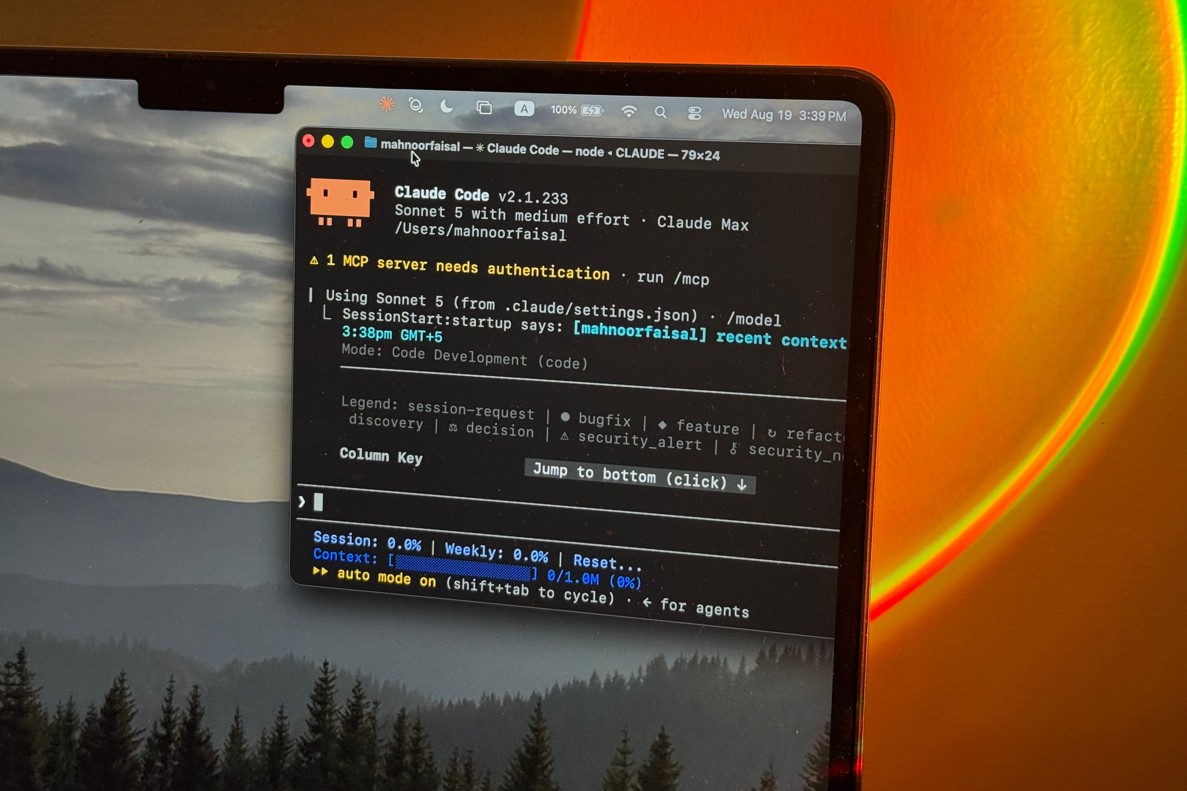 Claude Code on MacBoook with sunset lamp in the background