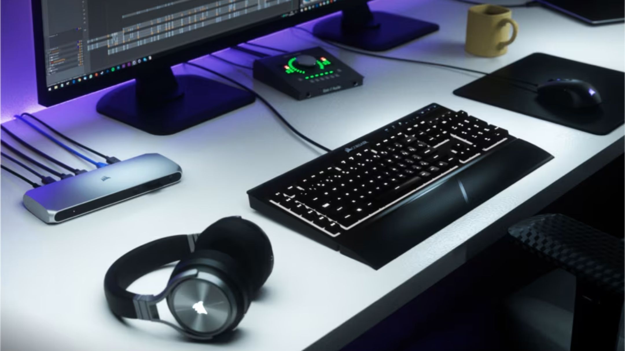 Corsair TBT100 DP Thunderbolt Dock next to keyboard and headphones on desk