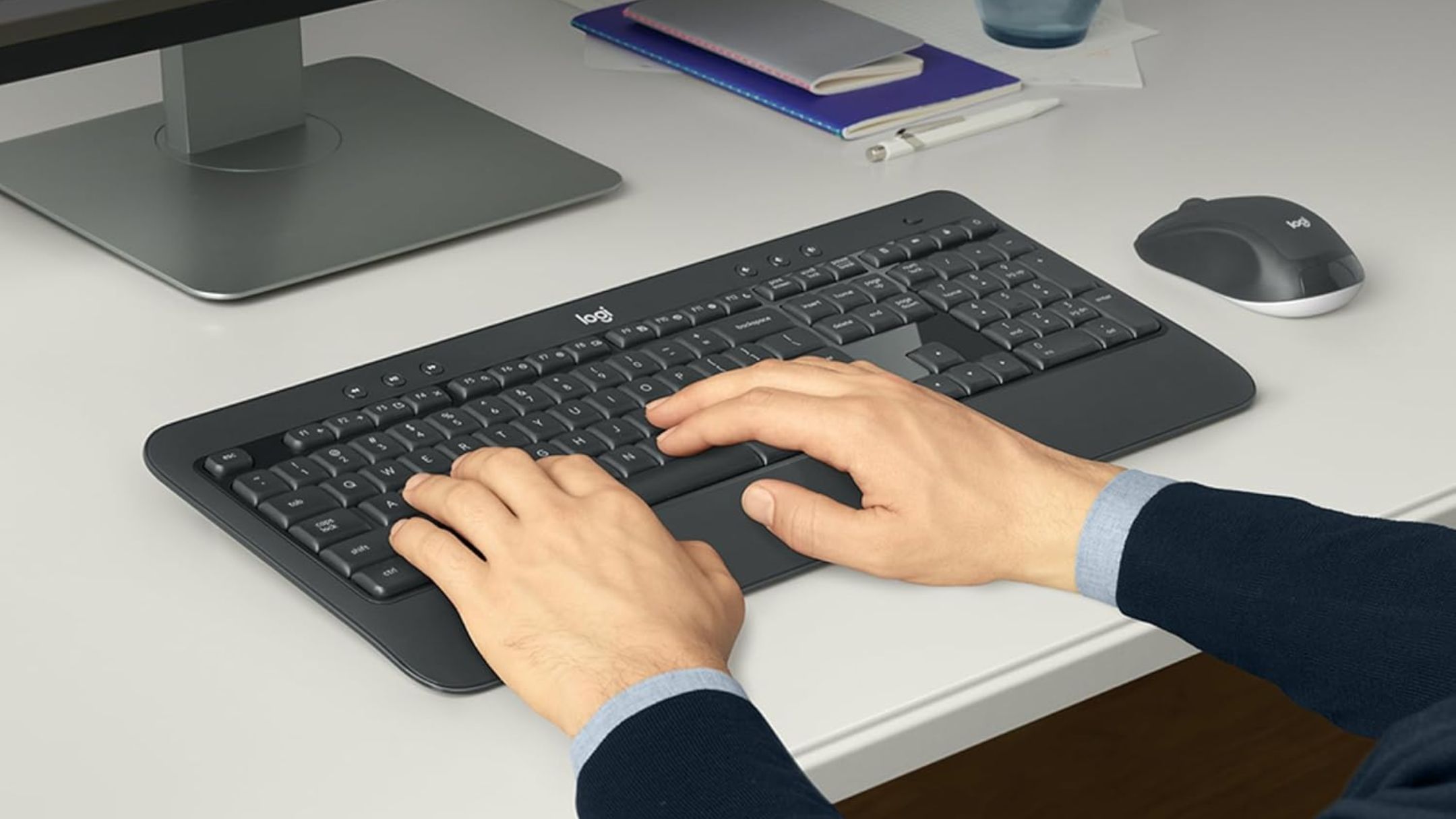 Person typing on Logitech MK540 