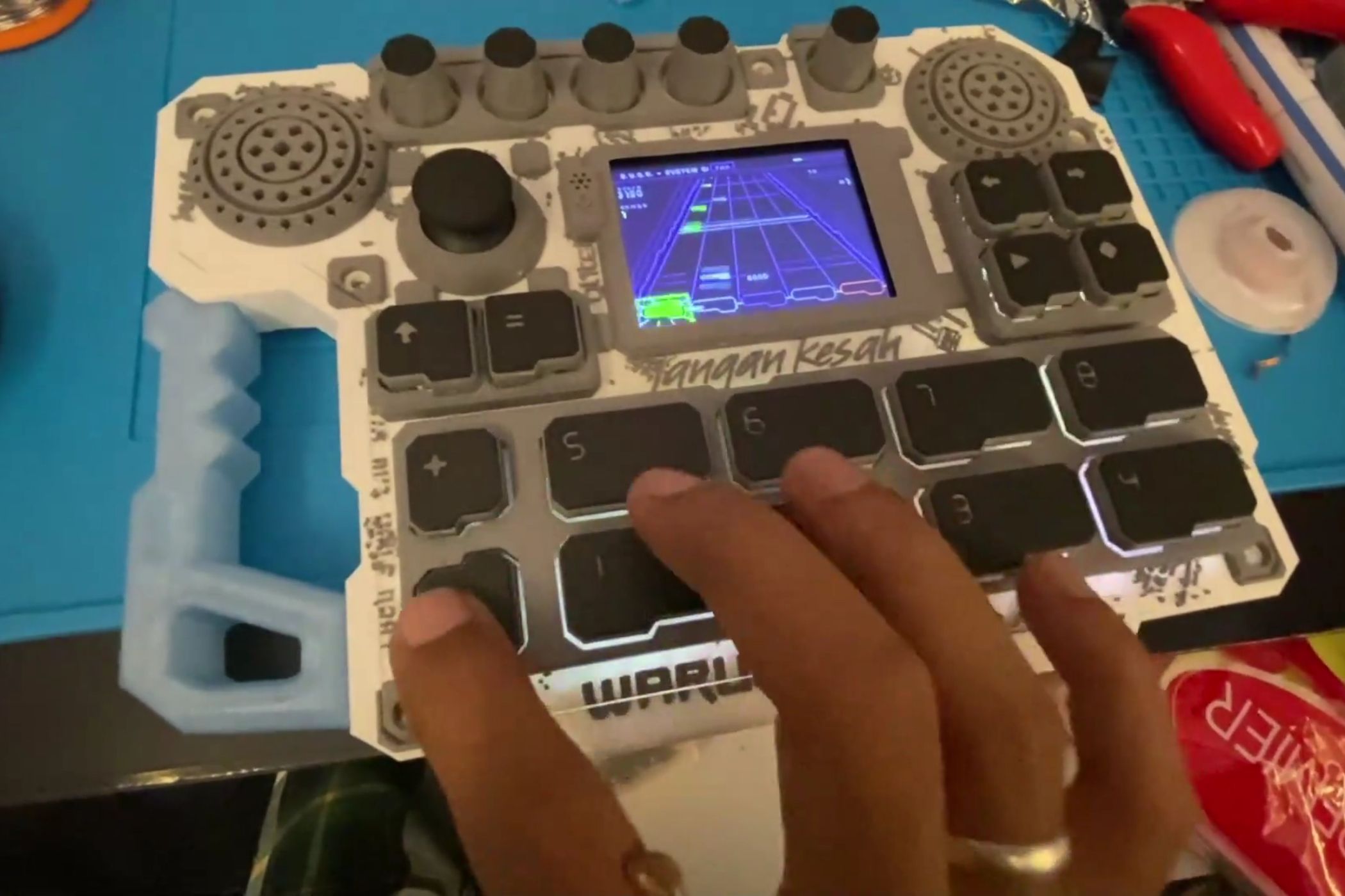 This ESP32 handheld is a retro emulator, FM synth, and Guitar Hero clone controller all in one