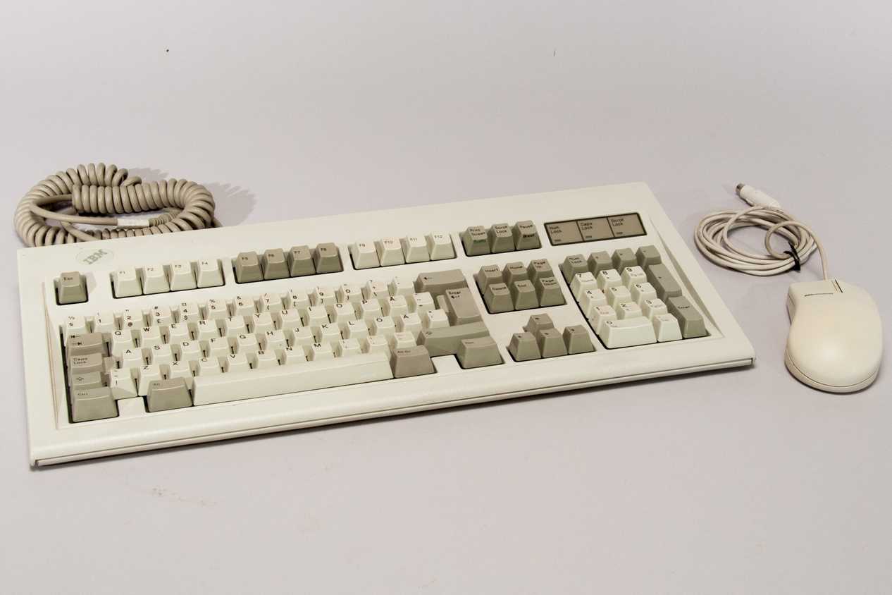 Retro keyboard and mouse on a white surface