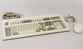 Retro keyboard and mouse on a white surface