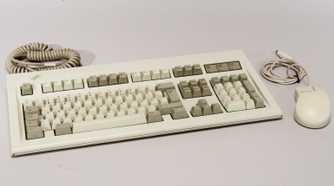 Retro keyboard and mouse on a white surface
