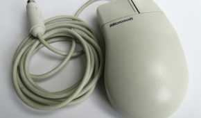 A white Microsoft mouse with a PS/2 cable