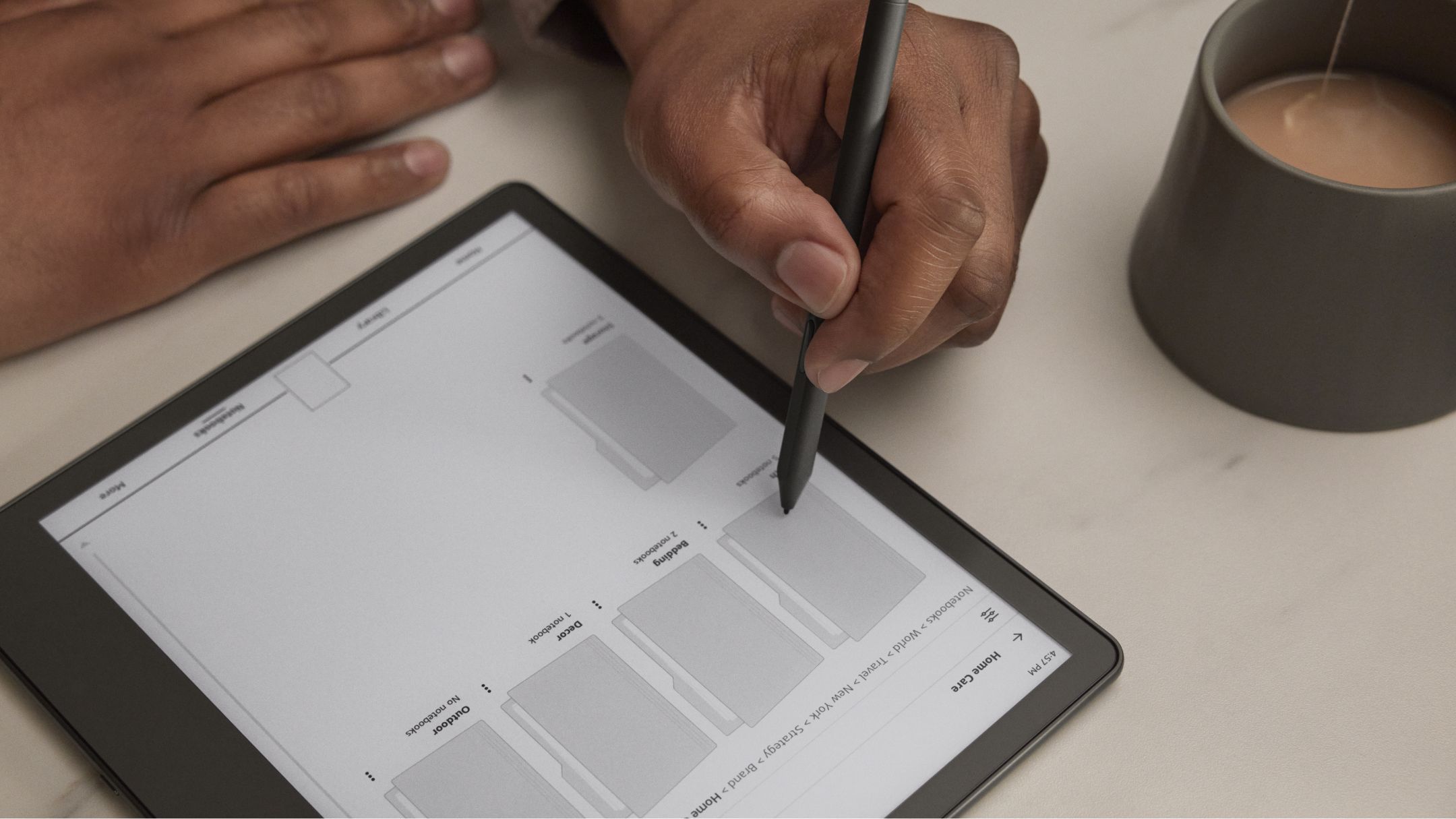 Person writing with Amazon Kindle Scribe