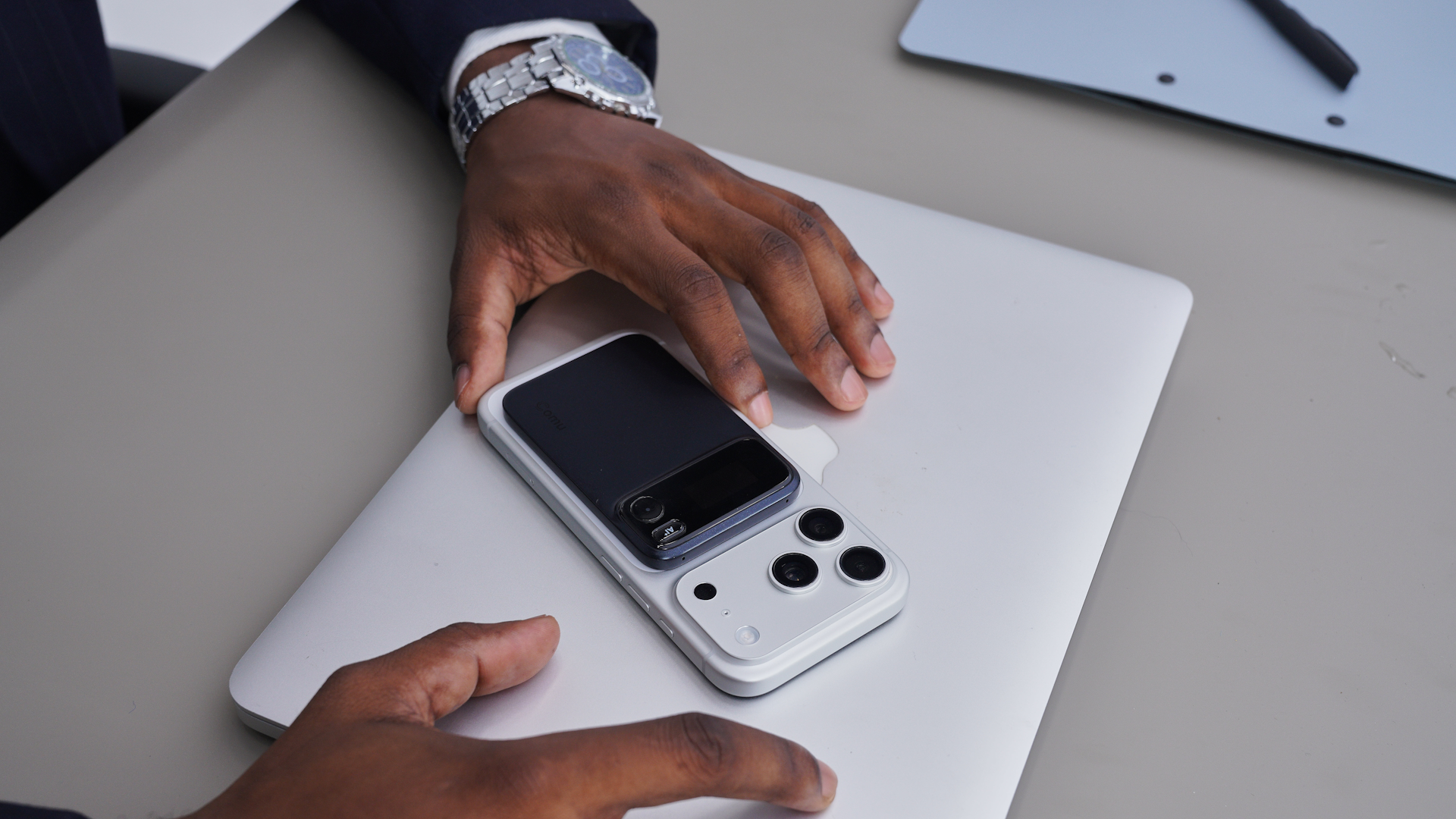 Comu Action Pro attached to smartphone on top of a laptop