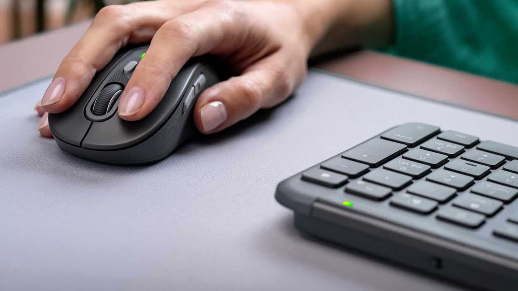 Person using Logitech MK955 Signature Slim Wireless Keyboard Mouse Combo 