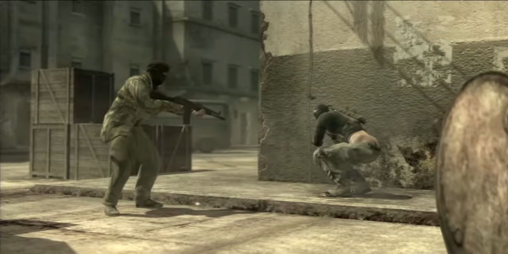 Sceenshot from Metal Gear Solid 4: Guns of the Patriots video game of two armed soldiers with one squatting