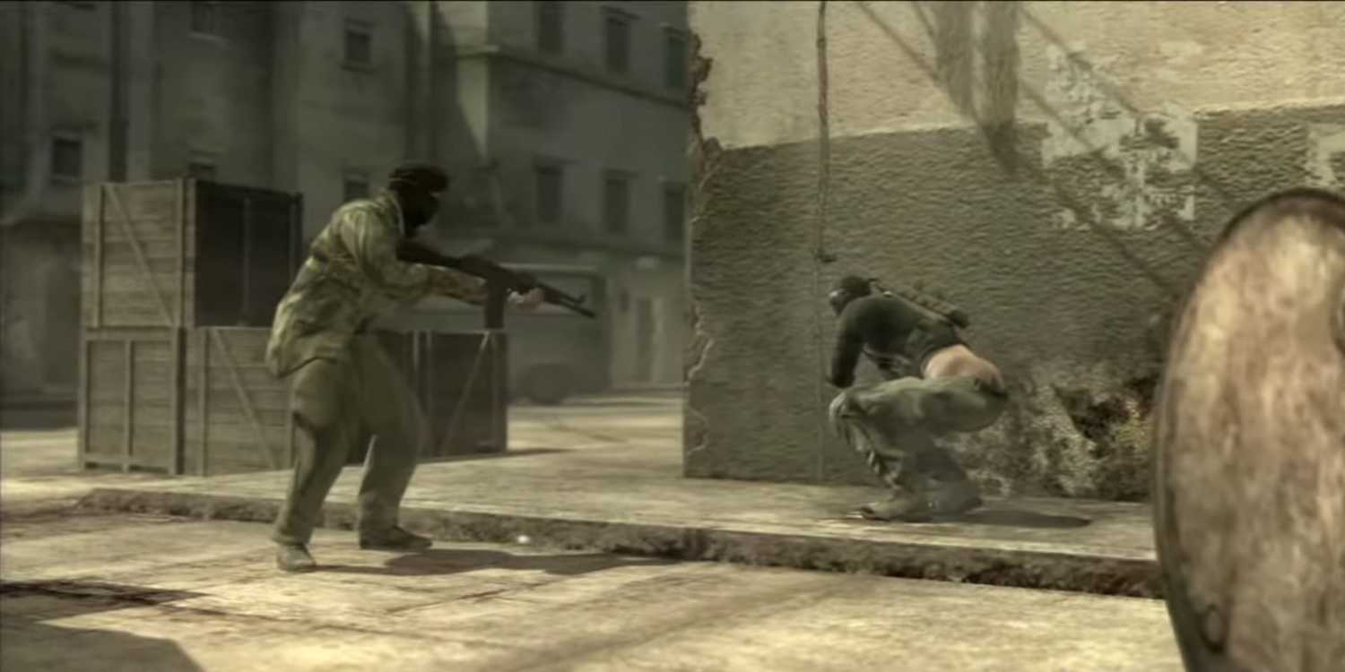 Sceenshot from Metal Gear Solid 4: Guns of the Patriots video game of two armed soldiers with one squatting