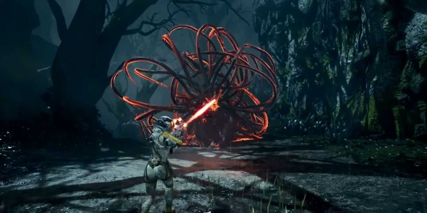 Screenshot from video game Returnal of Selene fighting giant tentacle alien in forest setting.