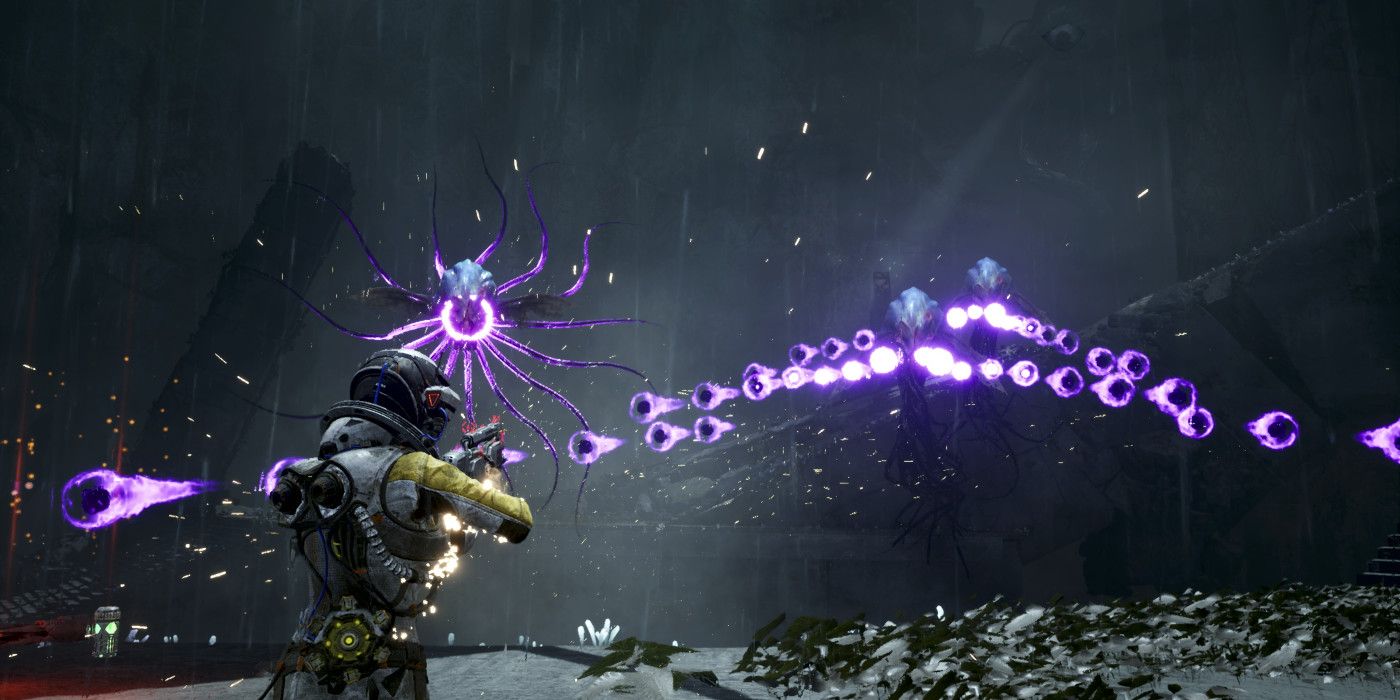 Screenshot from Returnal video game of Selene fighting squid-like alien creatures who are firing damaging energy orbs at her.