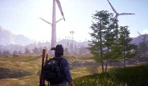 A man walking towards a field of wind turbines