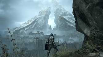 demon souls overlooking a castle with a big mountain behind it