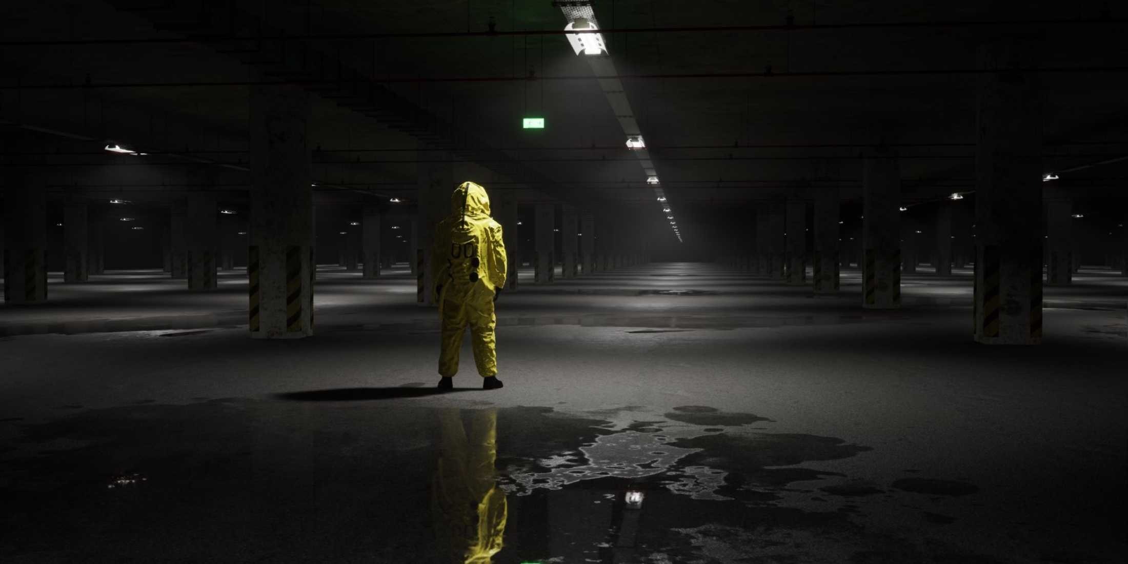 A man in a hazmat suit in a dark underground parking lot