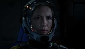 Screenshot from Returnal video game of main character Selene in space suit.