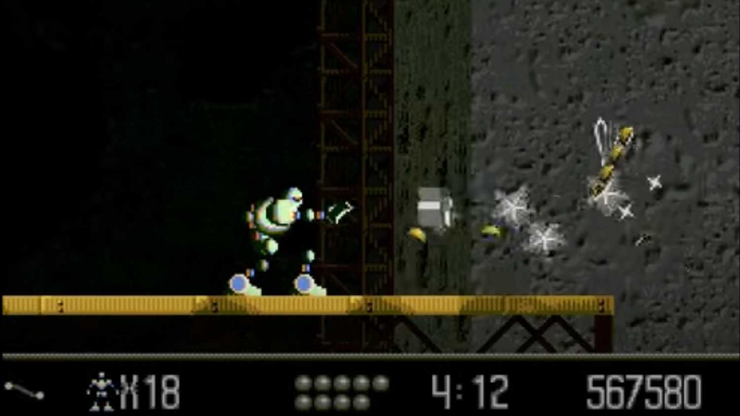 A screenshot of Vectorman firing blast against enemies
