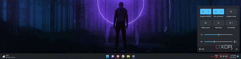 Screenshot of the Windows 11 taskbar showing how to open the Quick Settings panel