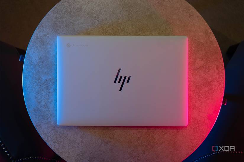 Top down view of white HP laptop with blue and pink lighting