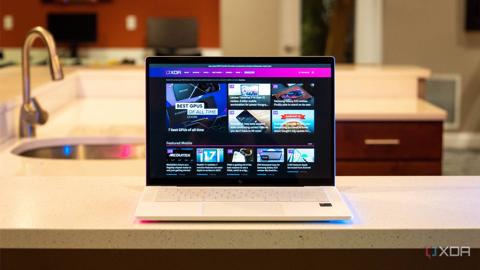 Front view of white laptop with XDA homepage