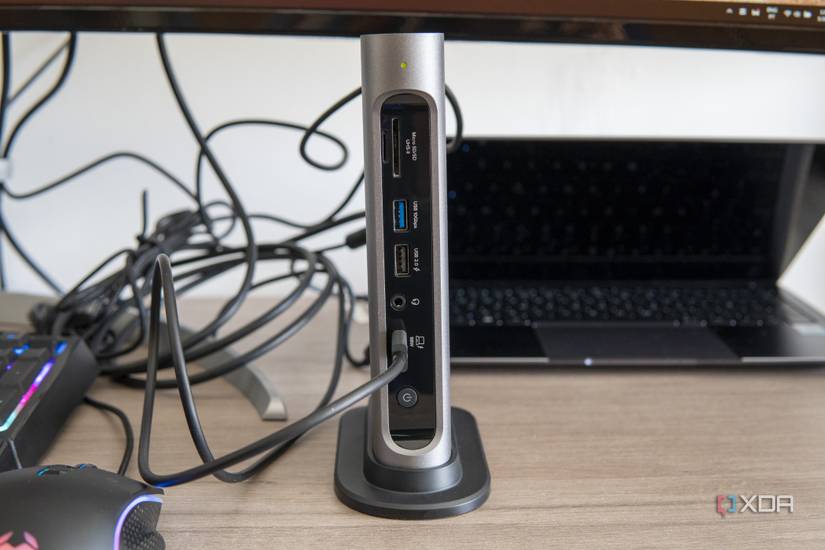 Front view of the Plugable 16-in-1 Thunderbolt 4 Dock in front of a laptop and next to other peripherals on a desk
